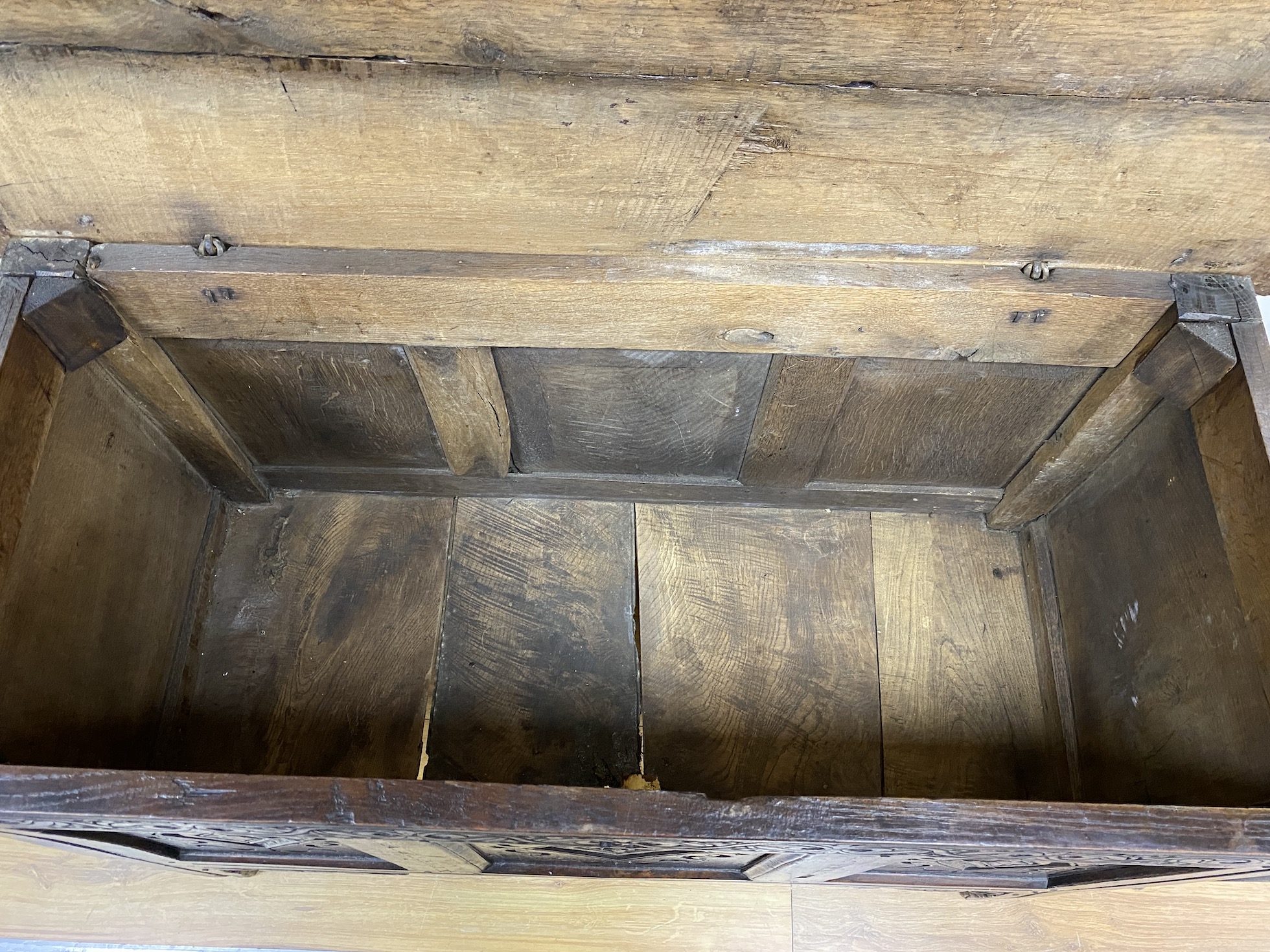 A late 17th century oak coffer the front carved with three lozenge medallion panels, length 115cm, depth 51cm, height 74cm